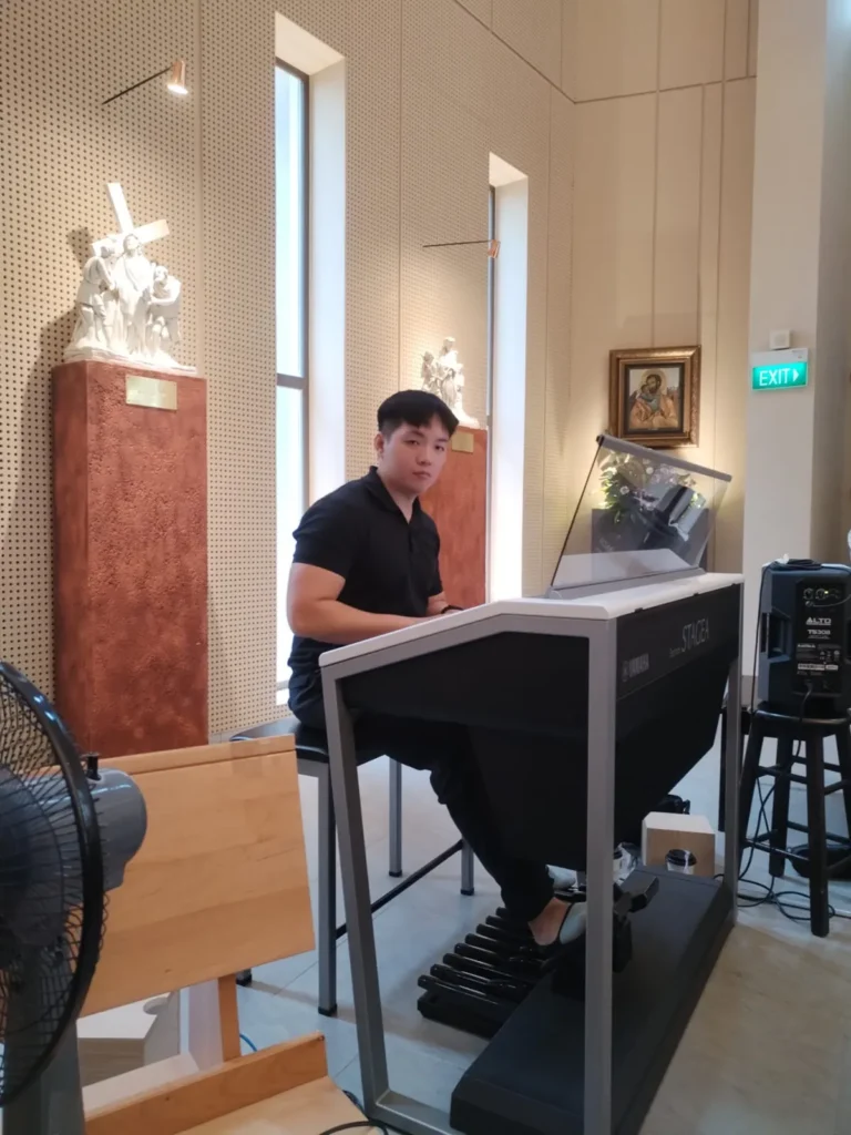 Augustine at the organ console in a parish church