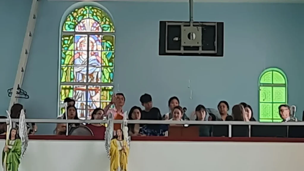 A visiting choir singing from the loft at a wedding Mass